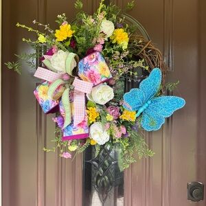 Floral Wreath with Blue Butterfly and Colorful Bow
